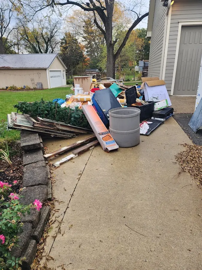 Dumpster being loaded with debris for Estate Cleanout Dumpster Rental in Vienna